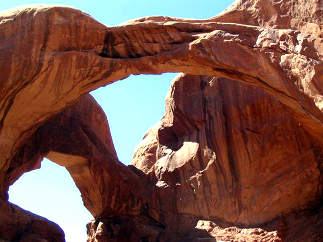 Double Arch.  There are dark streaks down the rock.