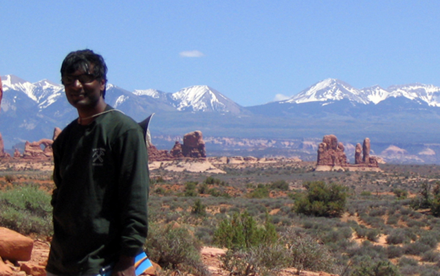 Dr. Anandakrishnan at Arches with the La Sal Mountains in the background.