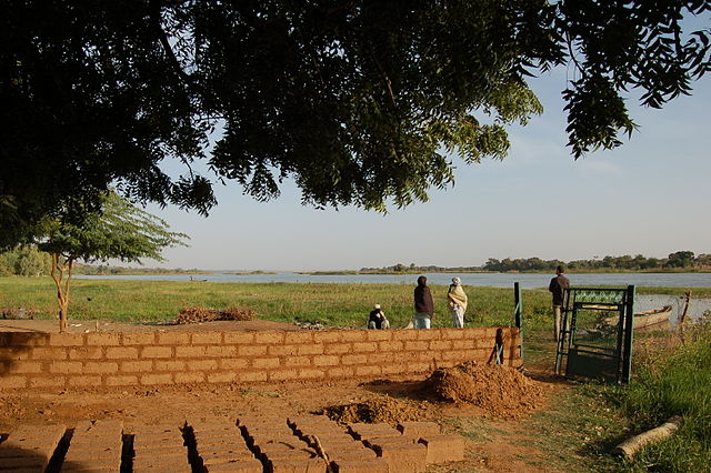 mudbrick construction at the edge of a river