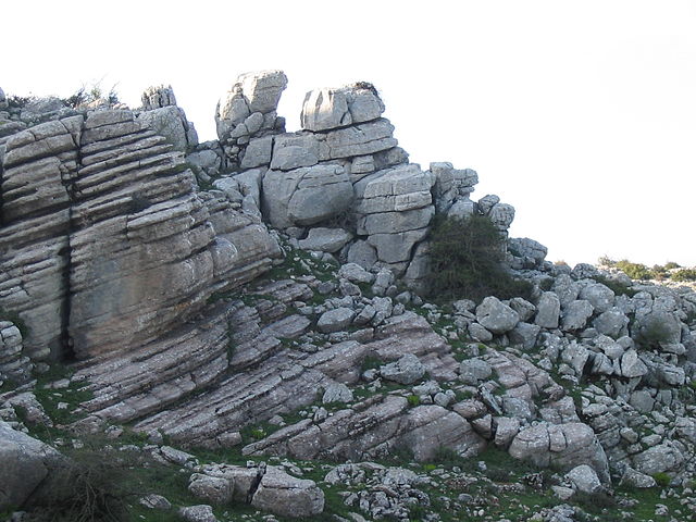 Limestone formations, edge of a cliff. Striated rocks with sloped horizontal lines