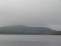 A foggy, rainy day at a lake.