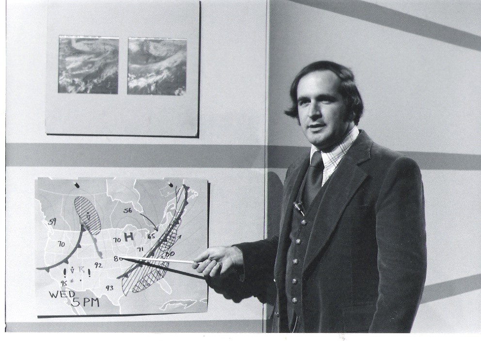 Photograph of Elliot Abrams presenting a television forecast in the 1970s.